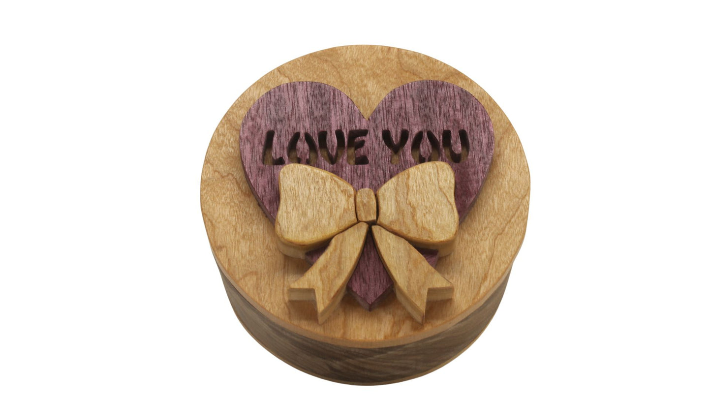 Round storage box with heart and bow on top