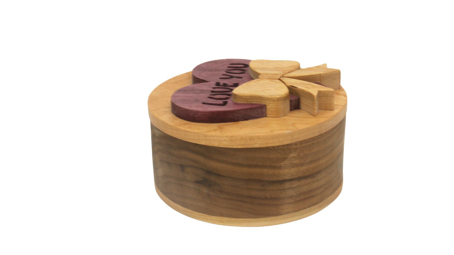 Round storage box with heart and bow on top