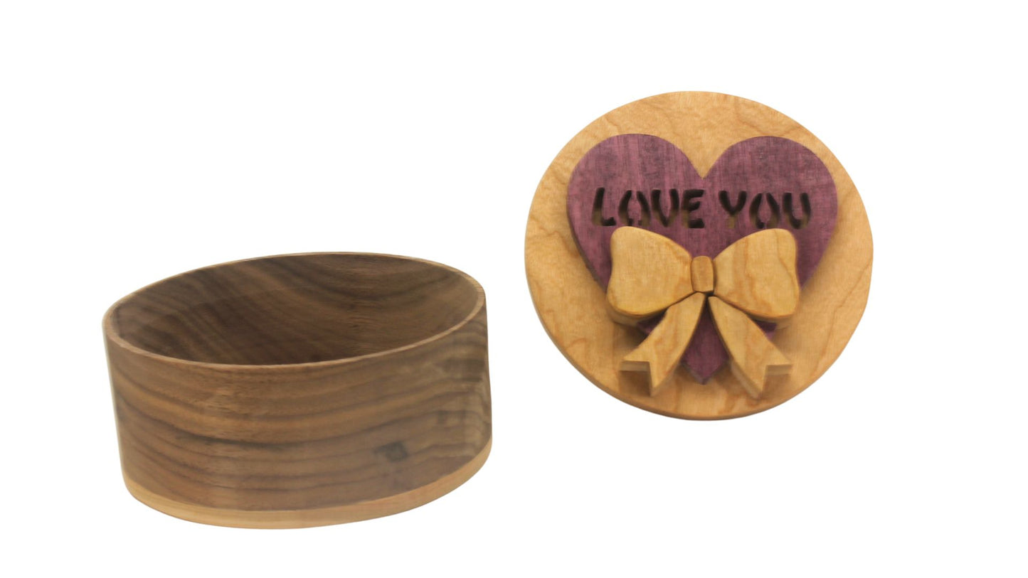 Round storage box with heart and bow on top