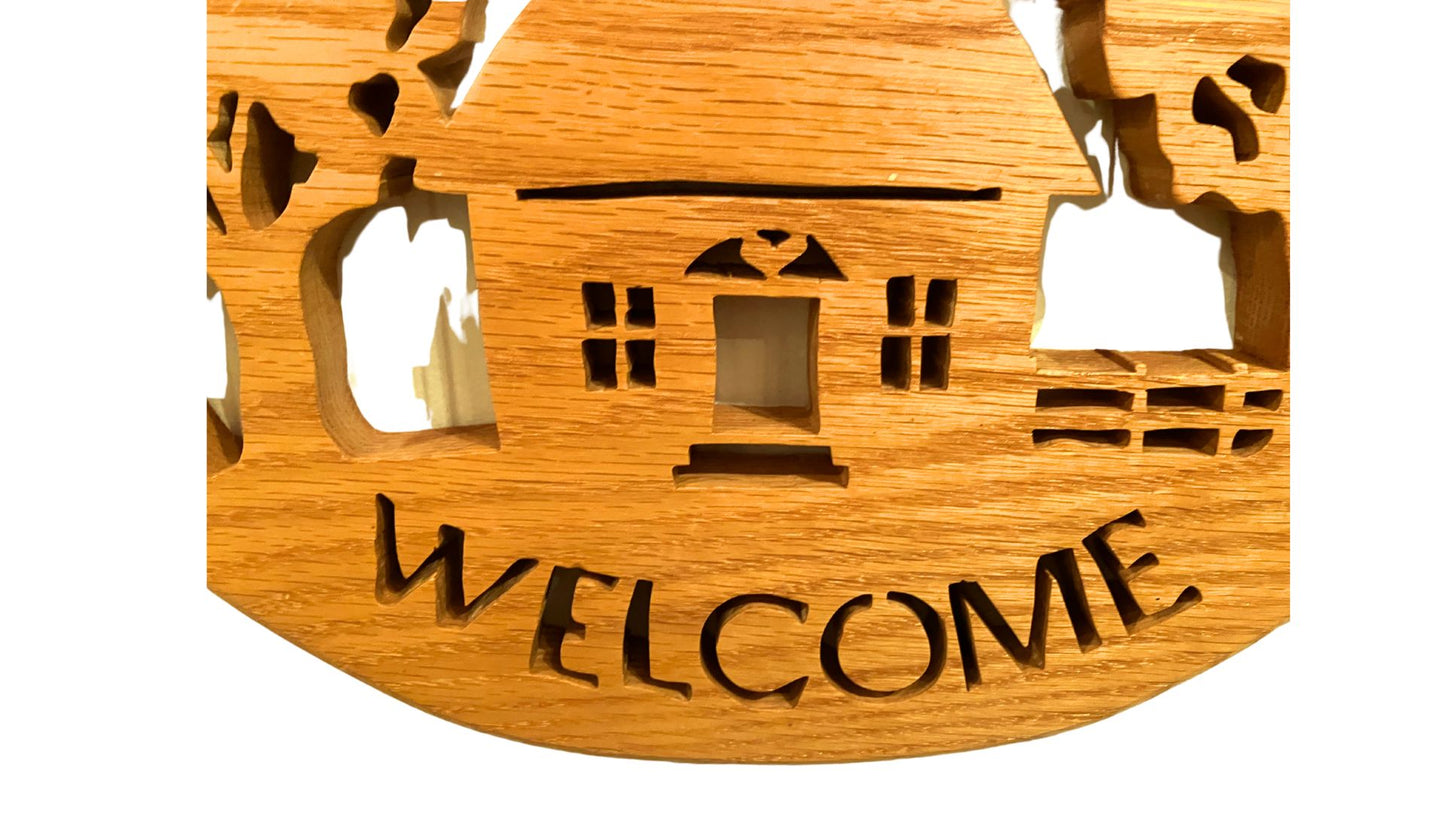 Oval welcome sign, hand cut from solid oak. This makes a great entry door or hall wall hanging