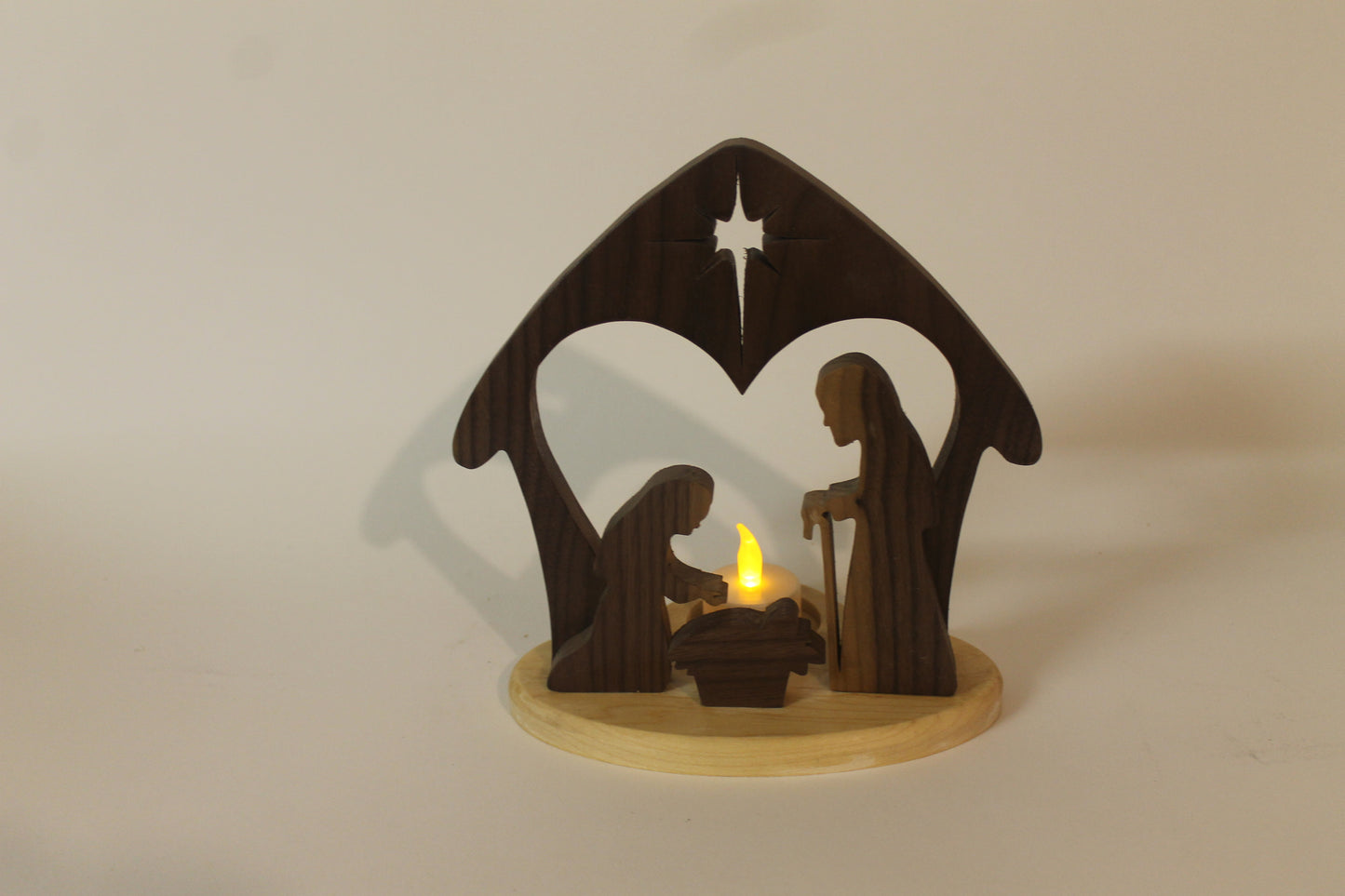 Nativity set, backlit by electric candle