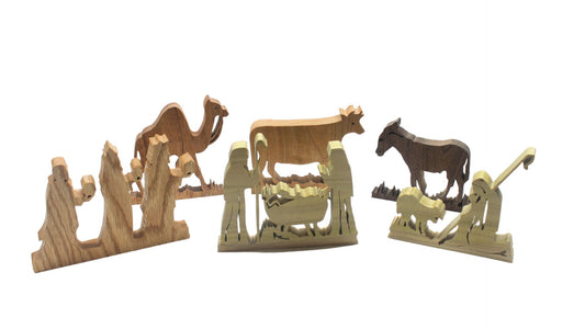 Nativity set, freestanding figures and animals. Mary, Joseph, baby Jesus, shepherd, kings, donkey, cow, camel. Hand cut from hardwoods