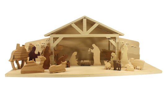 Multi-piece wood nativity with stable and figures, town of Bethlehem in the background